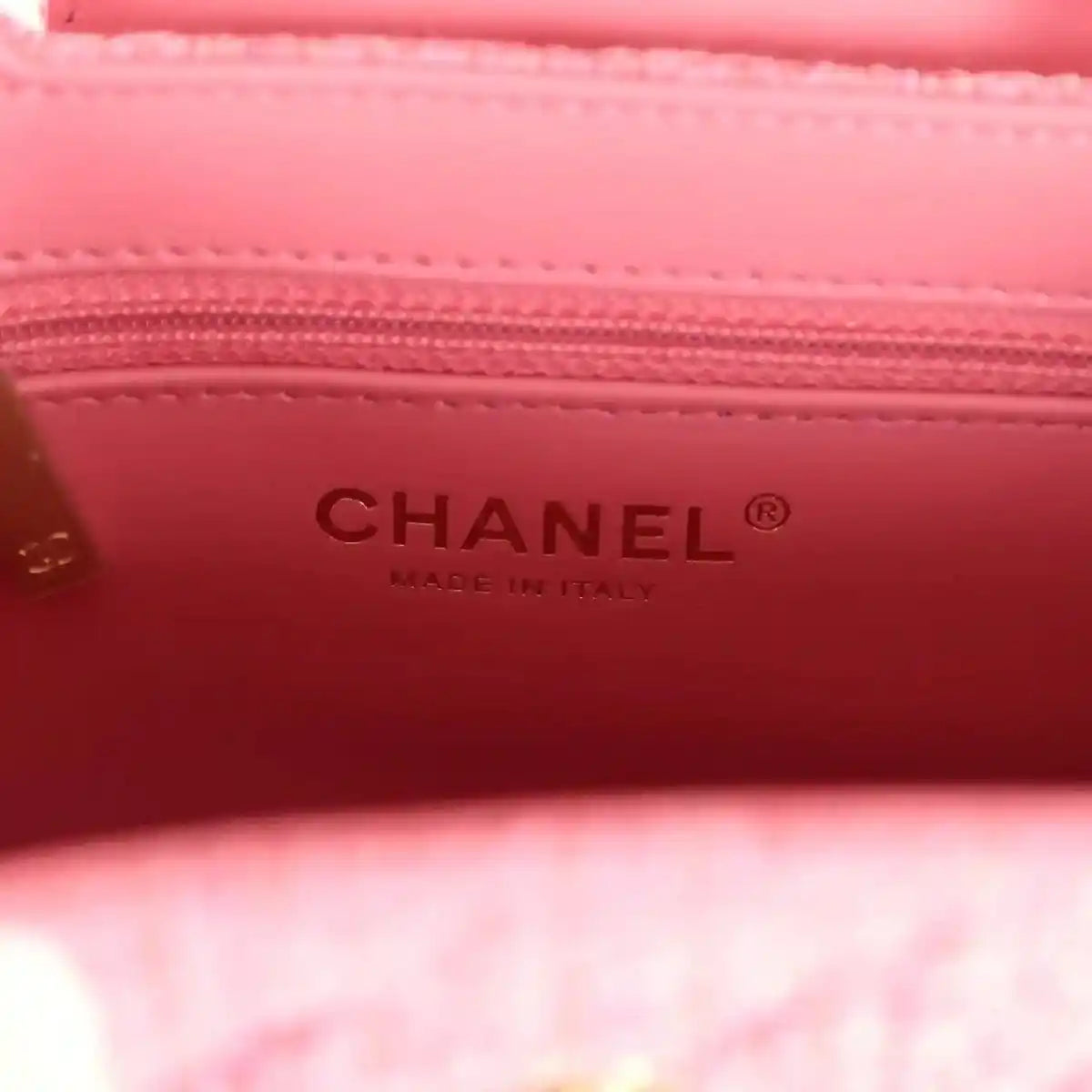 Pink leather bag interior with CHANEL text and stitched trim