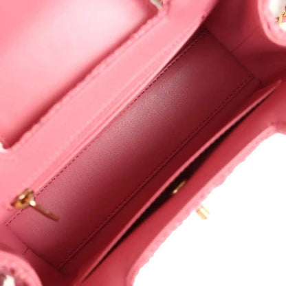 Pink leather interior with stitched edges and gold-tone zipper hardware