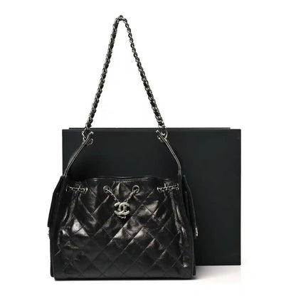 Chanel quilted black leather handbag with chain strap and CC emblem at front
