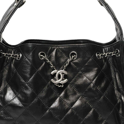 Chanel black quilted leather handbag front with CC emblem and chain links