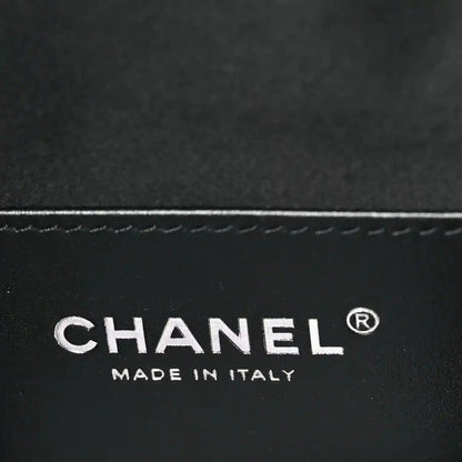 Chanel logo and “MADE IN ITALY” on black leather handbag surface