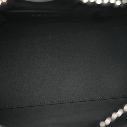 Black quilted leather handbag panel with visible stitching detail