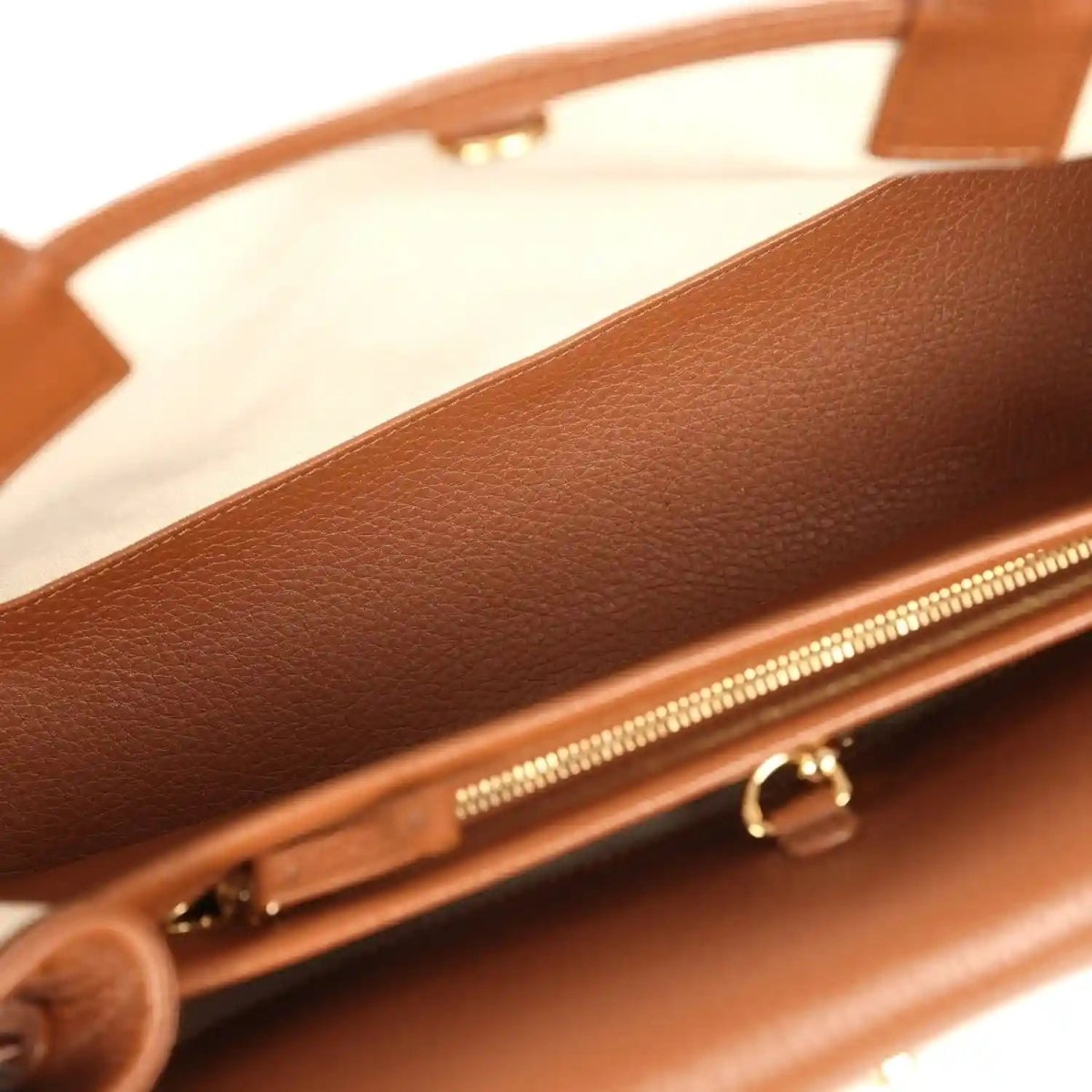 Chanel small tote bag close-up of top edge with gold-tone zipper and leather lining