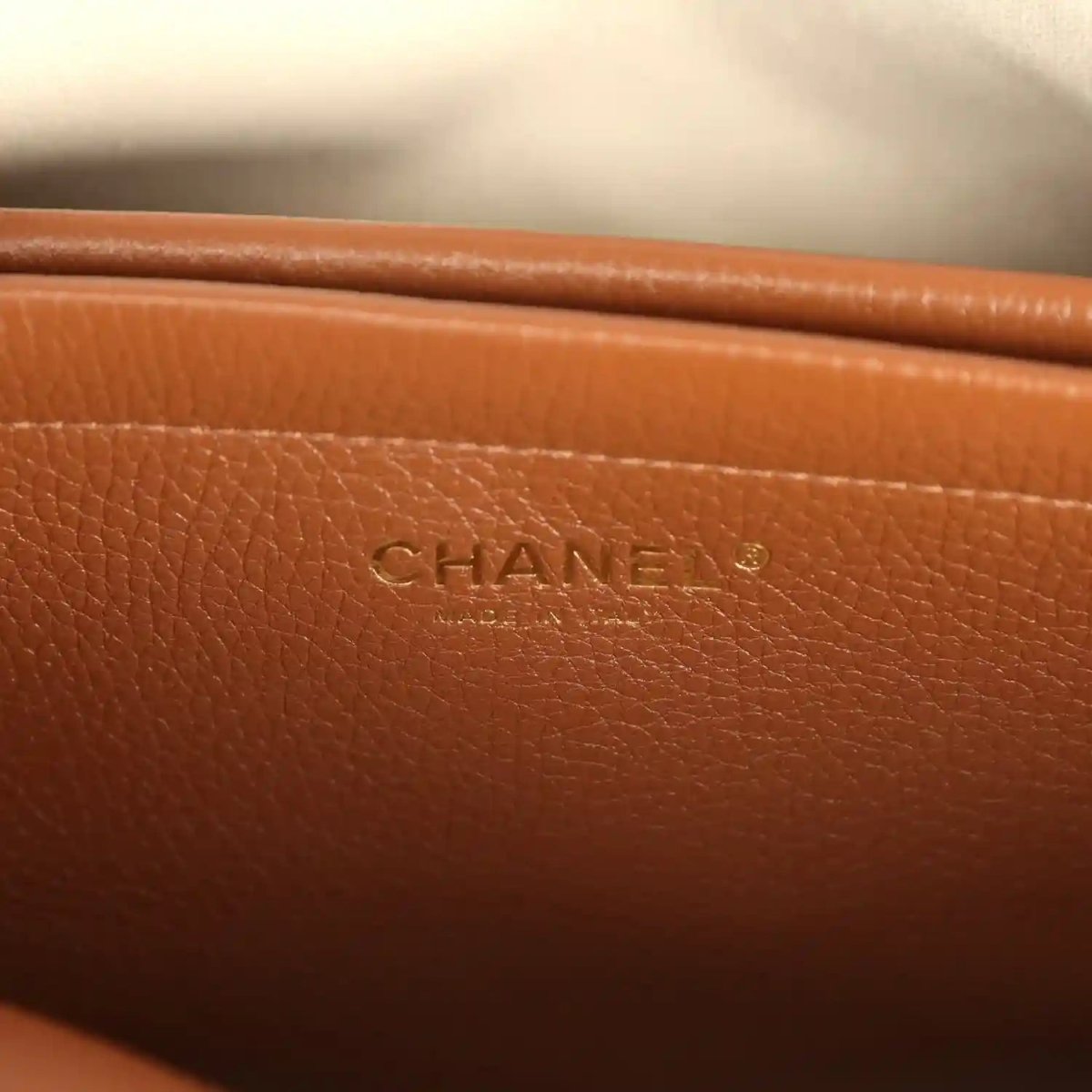 Chanel leather tote bag with CHANEL logo stamp on brown front panel
