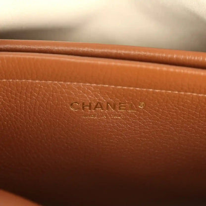 Chanel leather tote bag with CHANEL logo stamp on brown front panel