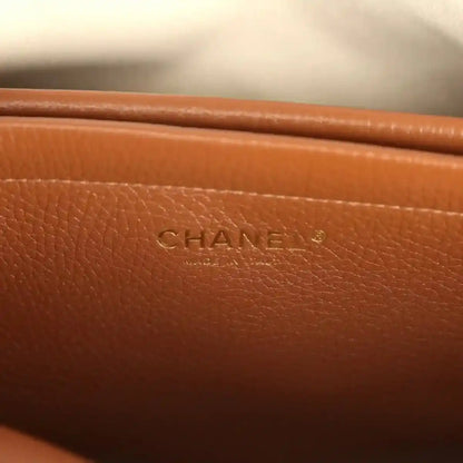 Chanel leather tote bag with CHANEL logo stamp on brown front panel