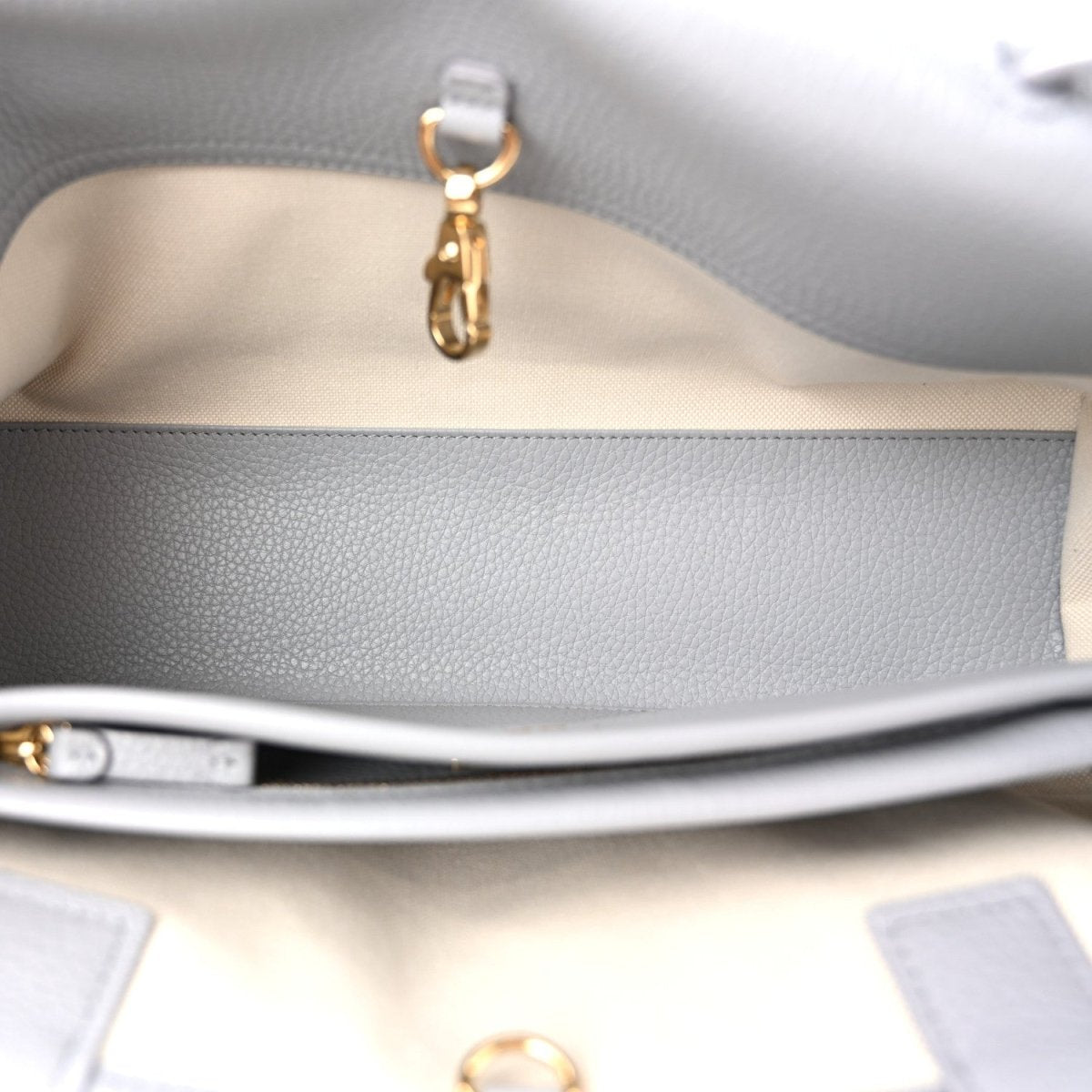 CHANEL small shopping bag interior detail with gold-toned clasp on lining