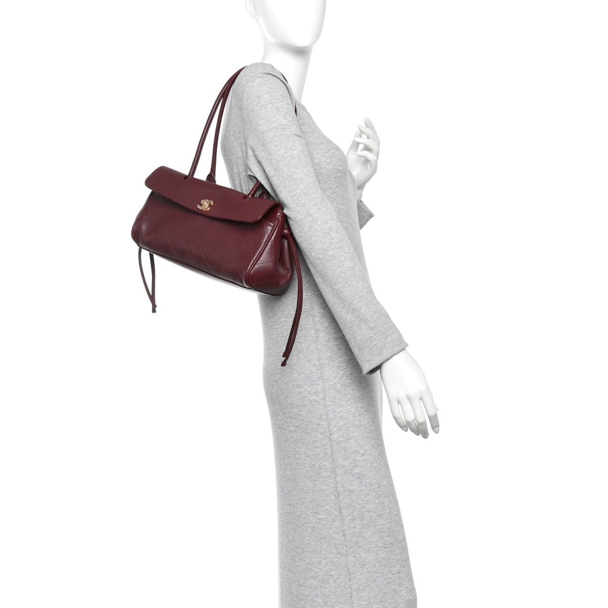 Chanel small burgundy shopping bag on model with top handles and flap front