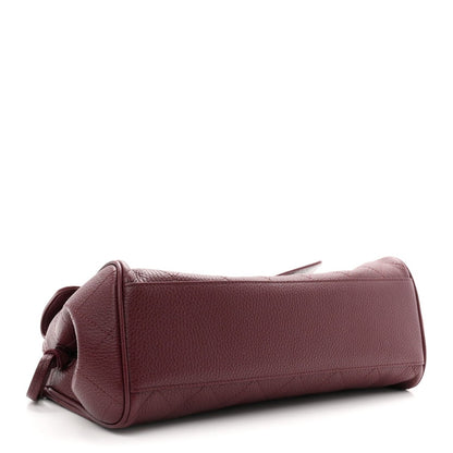 Chanel burgundy grained calfskin small shopping bag side view with stitched edge