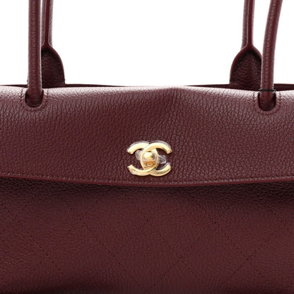 Chanel burgundy grained calfskin bag with gold-tone CC emblem on flap