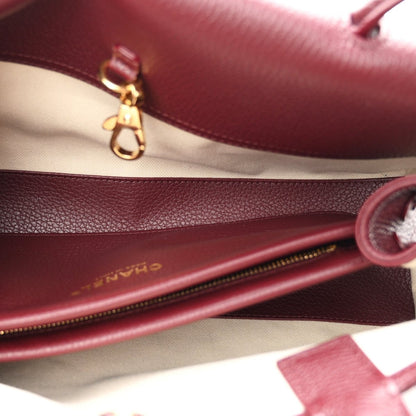 Chanel burgundy calfskin bag interior with zip edge and gold-tone clasp