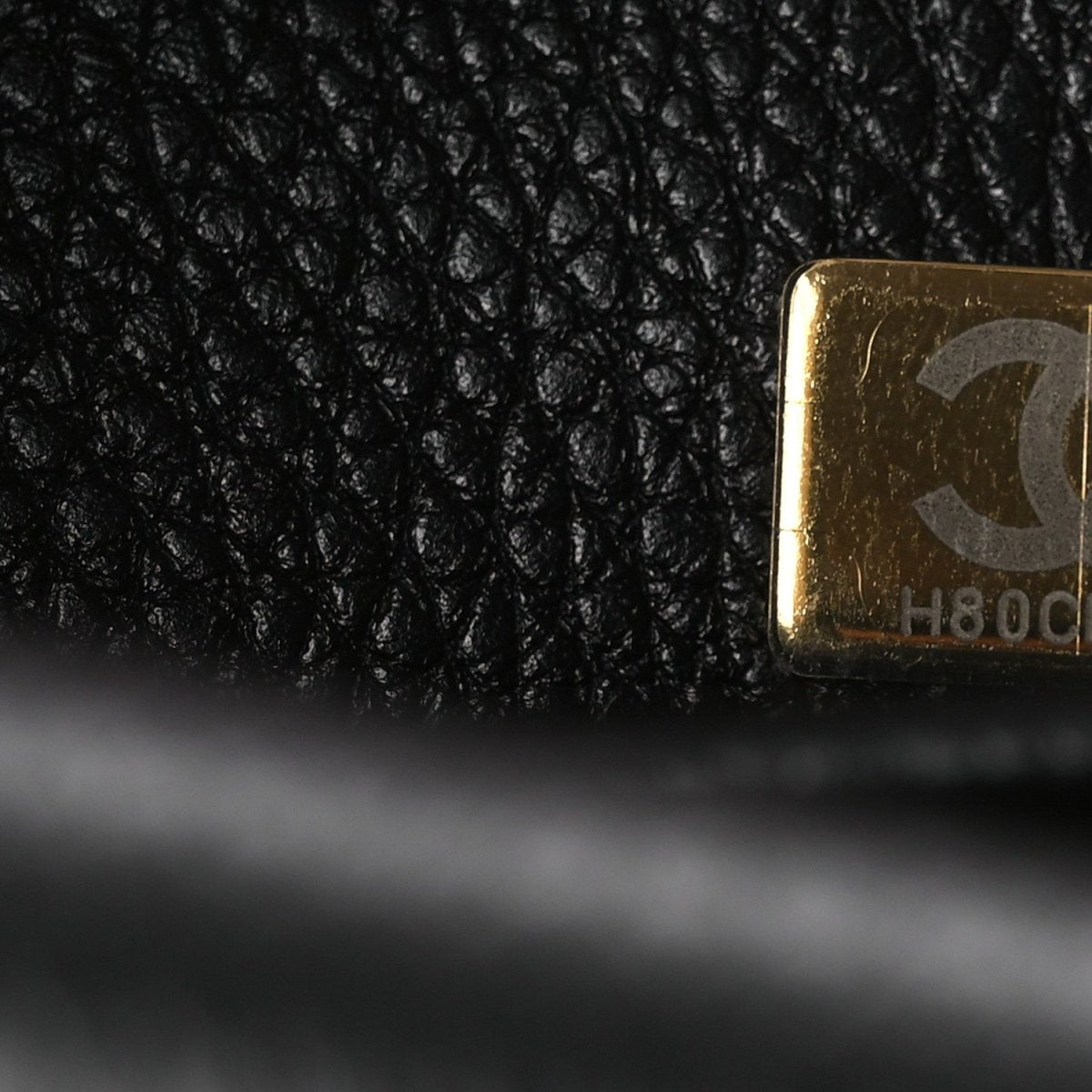 Chanel gold label corner on black leather lining