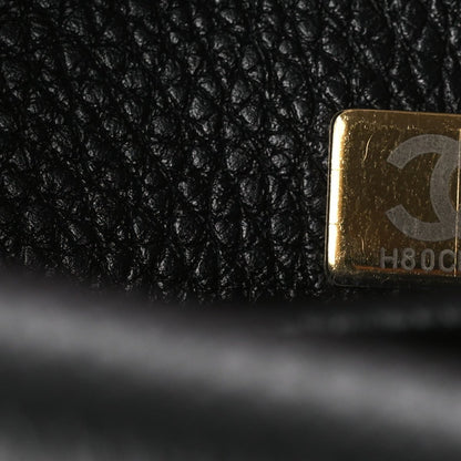 Chanel gold label corner on black leather lining