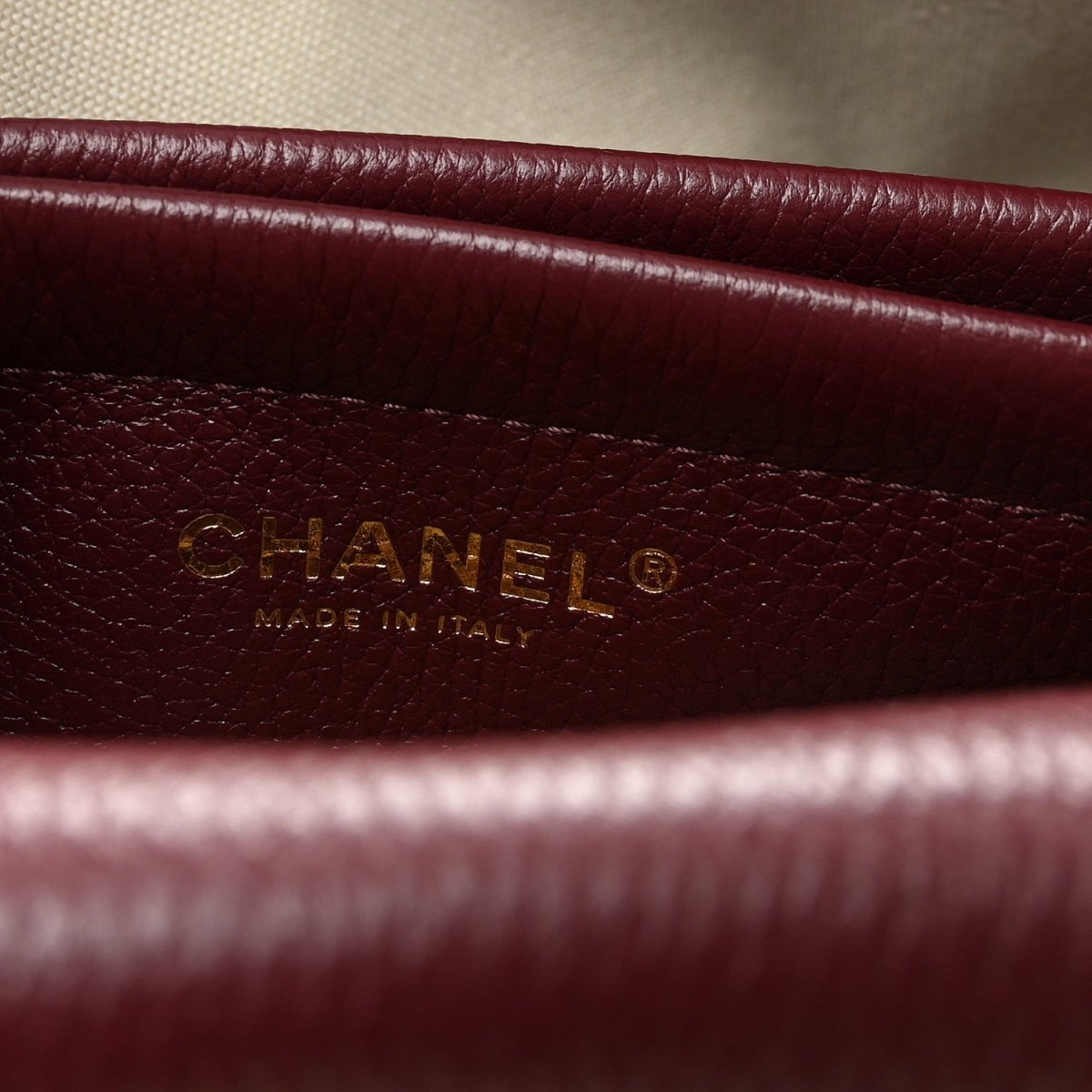 Burgundy leather label with CHANEL and “Made in Italy” text