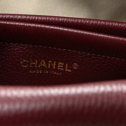 Burgundy leather label with CHANEL and “Made in Italy” text