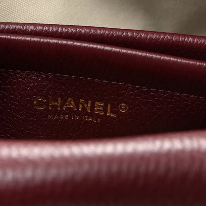Burgundy leather label with CHANEL and “Made in Italy” text