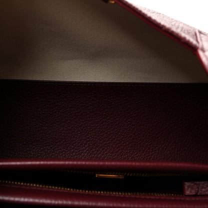 Burgundy leather interior with beige lining and zippered opening