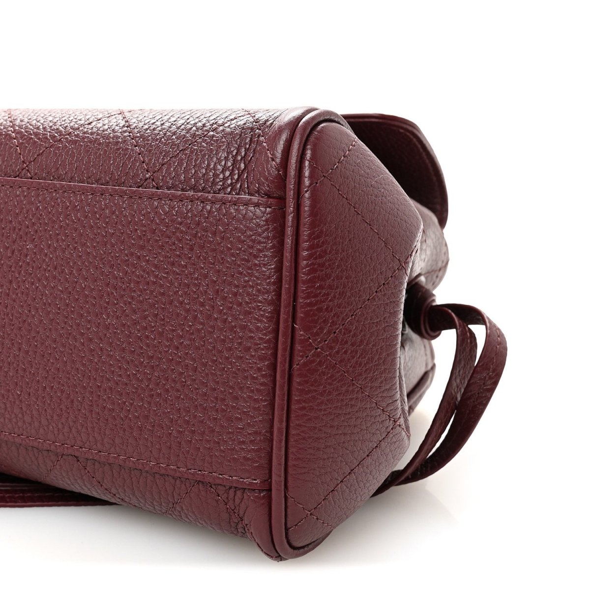 Burgundy grained leather side view with strap loop and stitched panel