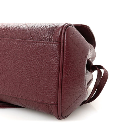 Burgundy grained leather side view with strap loop and stitched panel