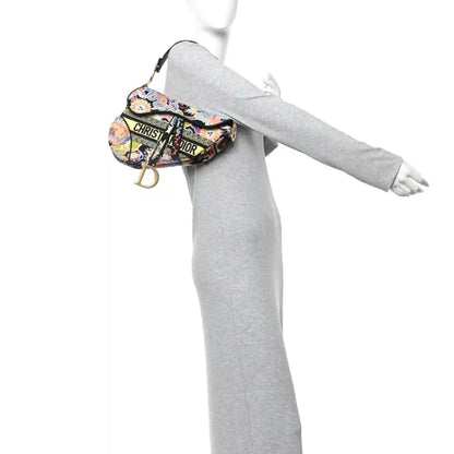 Embroidered canvas saddle bag with top handle, gold D charm; multicolor zodiac pattern