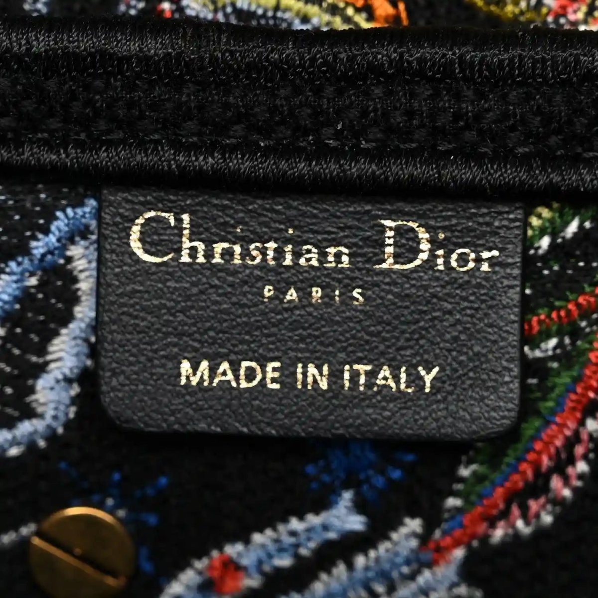 Leather brand patch reading 'Christian Dior' and 'Made in Italy'