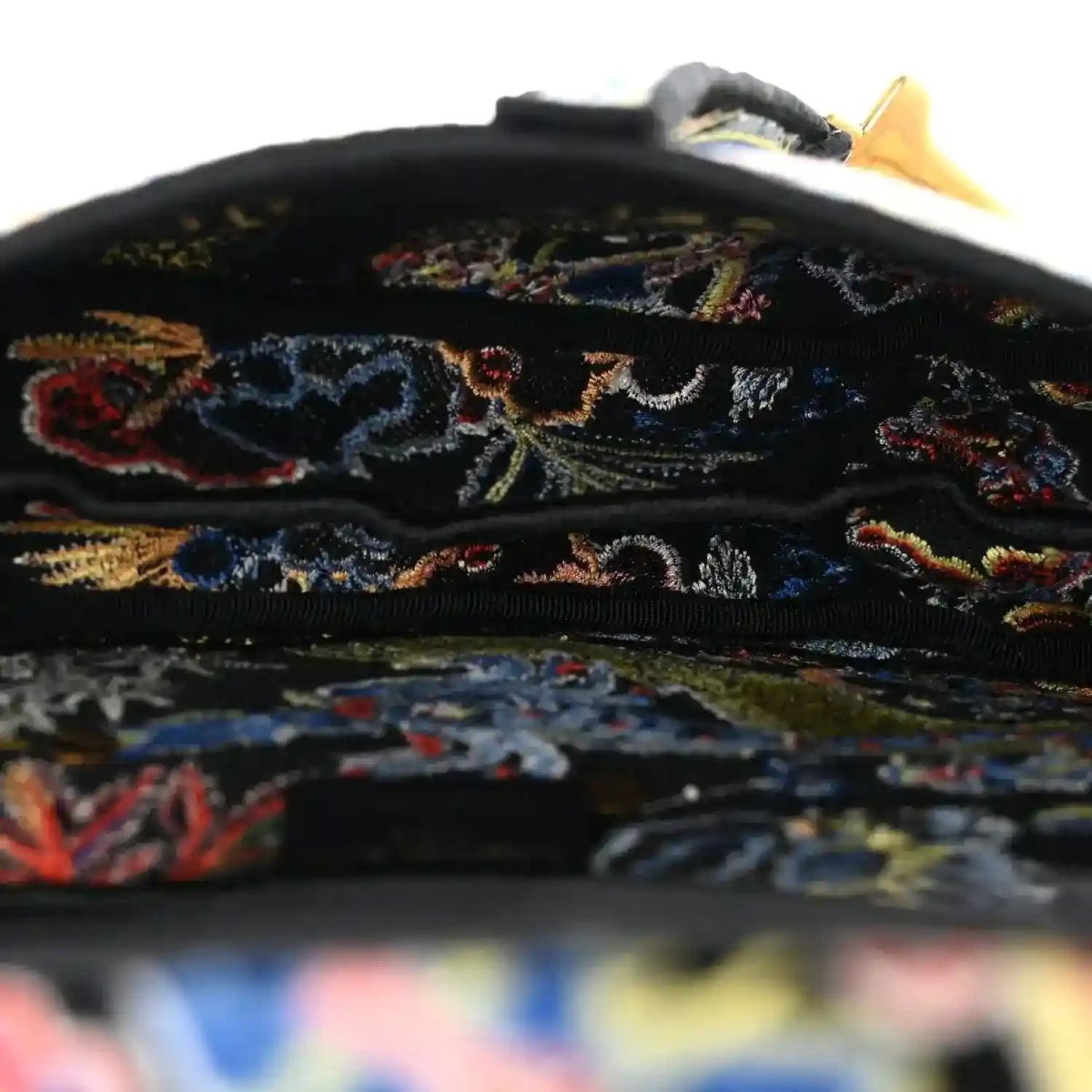 Black embroidered canvas interior flap edge with multicolor zodiac stitching