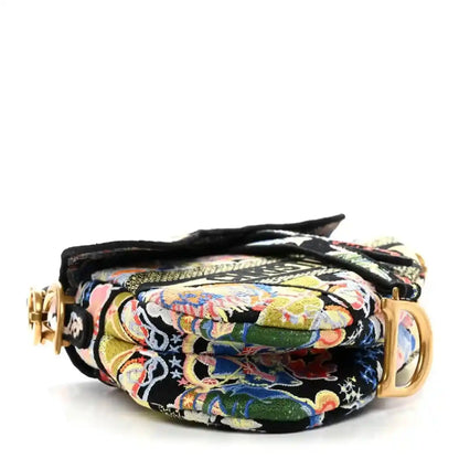 Embroidered canvas saddle bag with rolled flap and gold hardware, multicolor zodiac pattern