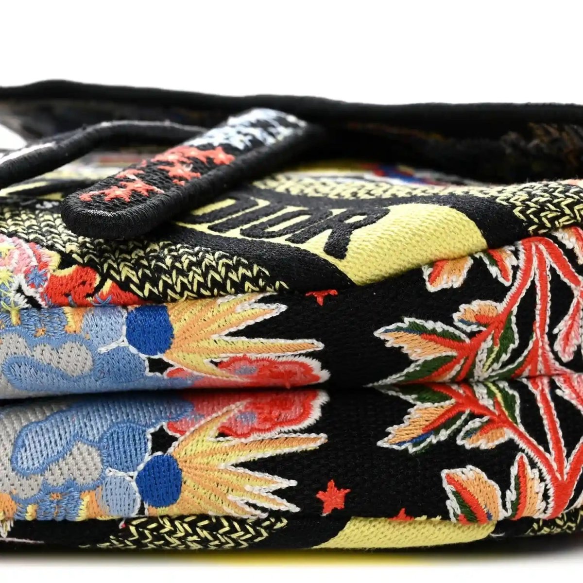 Black embroidered canvas side with colorful zodiac blossoms and black leather handle