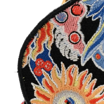 Black canvas embroidered zodiac motif saddle bag detail