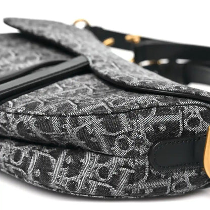 Black jacquard saddle bag with side strap and patterned fabric detail