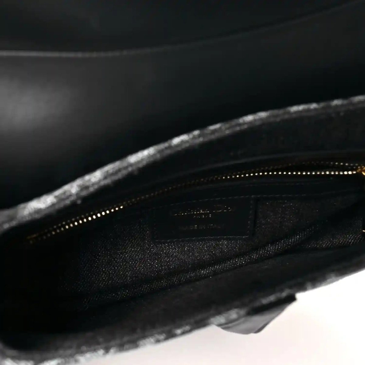 Black interior lining with zip opening inside the saddle bag
