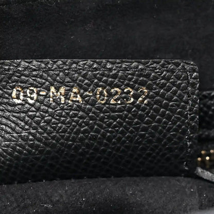 Christian Dior black leather bag interior stamp with alphanumeric code on grainy panel