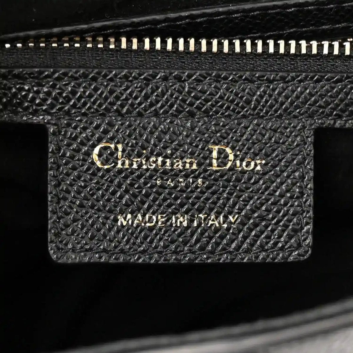 Black grained leather interior patch with Christian Dior Made in Italy stamp