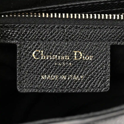Black grained leather interior patch with Christian Dior Made in Italy stamp