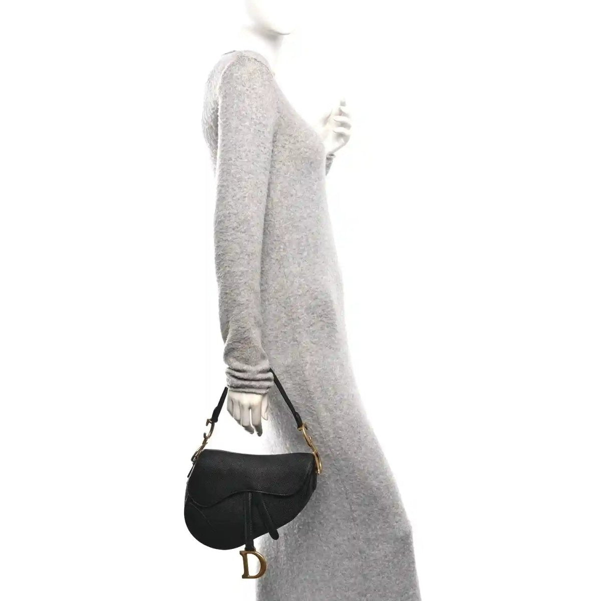 Christian Dior black grained calfskin saddle bag worn crossbody with gold-tone D buckle