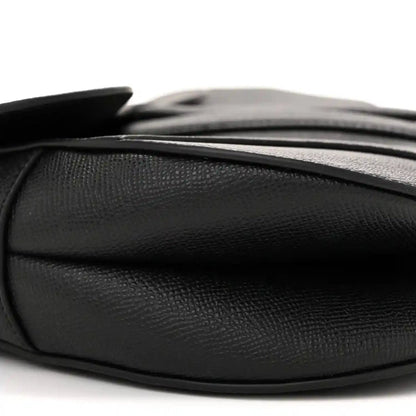 Black grained calfskin saddle bag with smooth side panel and top edge