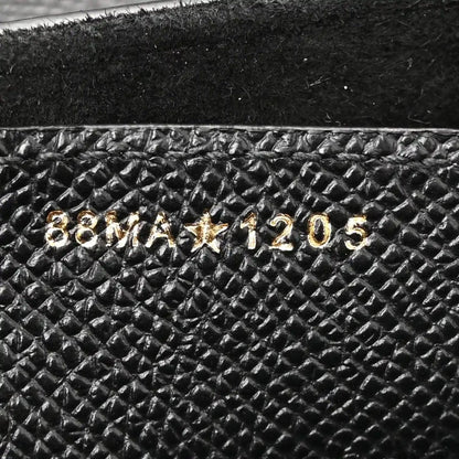 Gold stamped numbers on black grained leather interior lining