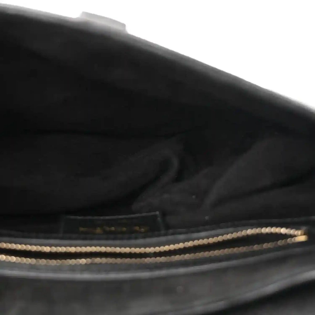 Black leather bag interior with zip opening and gold-toned trim