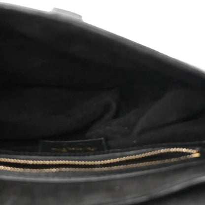 Black leather bag interior with zip opening and gold-toned trim
