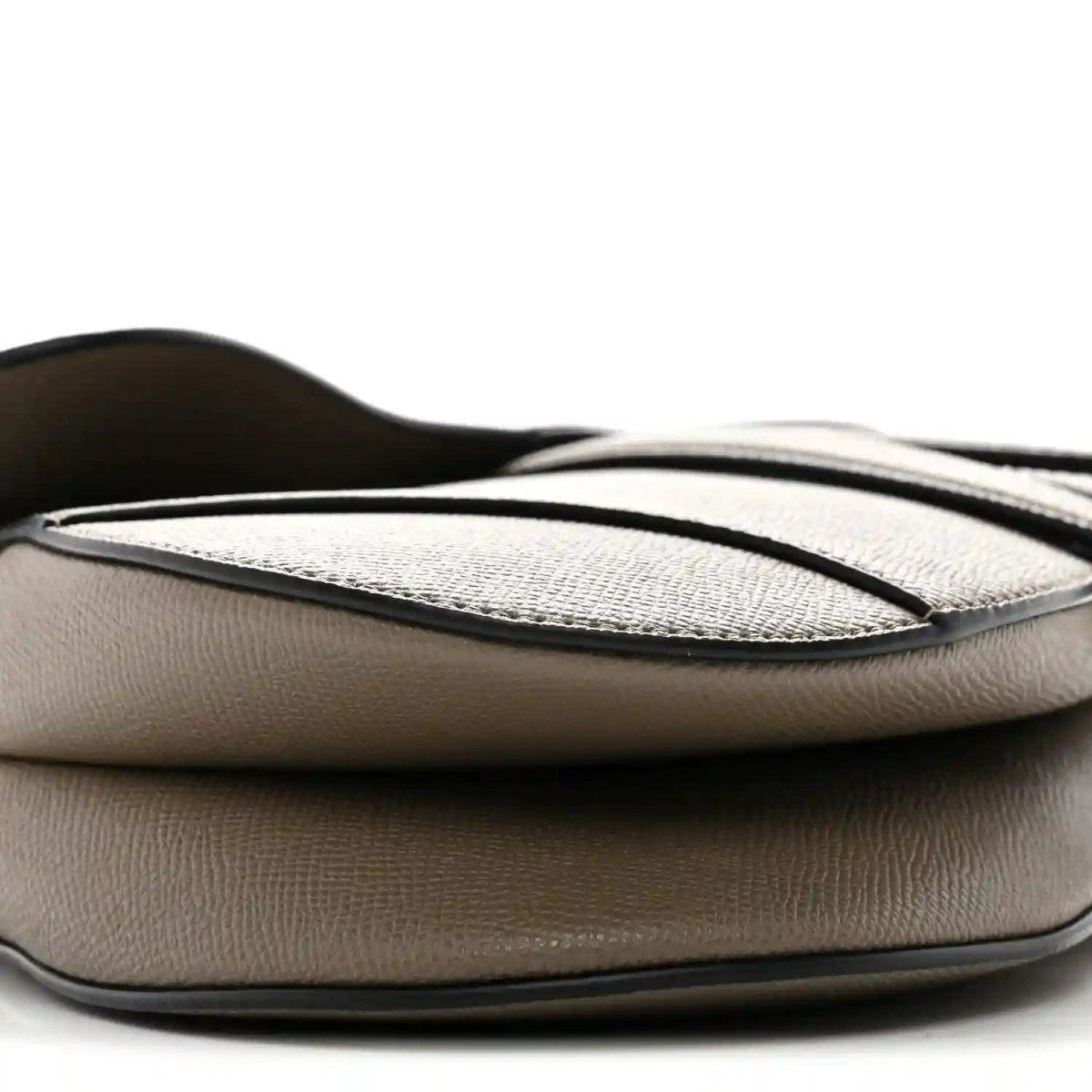 Close-up of flap and top panel on dark green grained calfskin saddle bag