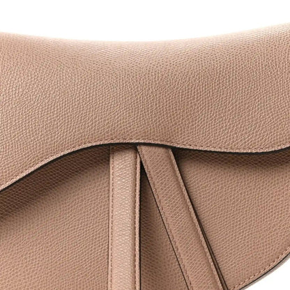 Grained leather flap detail with center drawstring and curved top edge