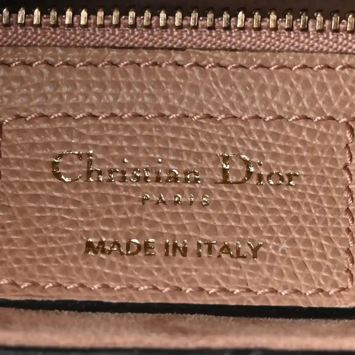 Interior leather label with text 'Christian Dior' and 'MADE IN ITALY'