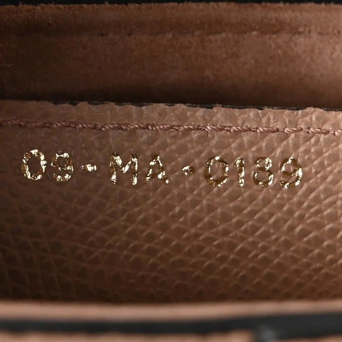 Embossed inner leather label reading 'DIOR' with 'Made in Italy' beneath