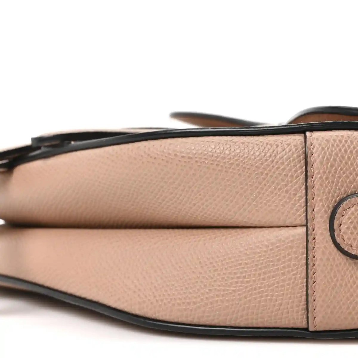 Light pink grained leather saddle bag side panel with black trim and strap loop