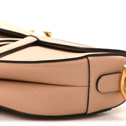 Light pink grained calfskin saddle bag side seam with tab pocket and gold buckle