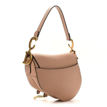 Light pink grained calfskin saddle bag with gold-tone D charm and adjustable strap