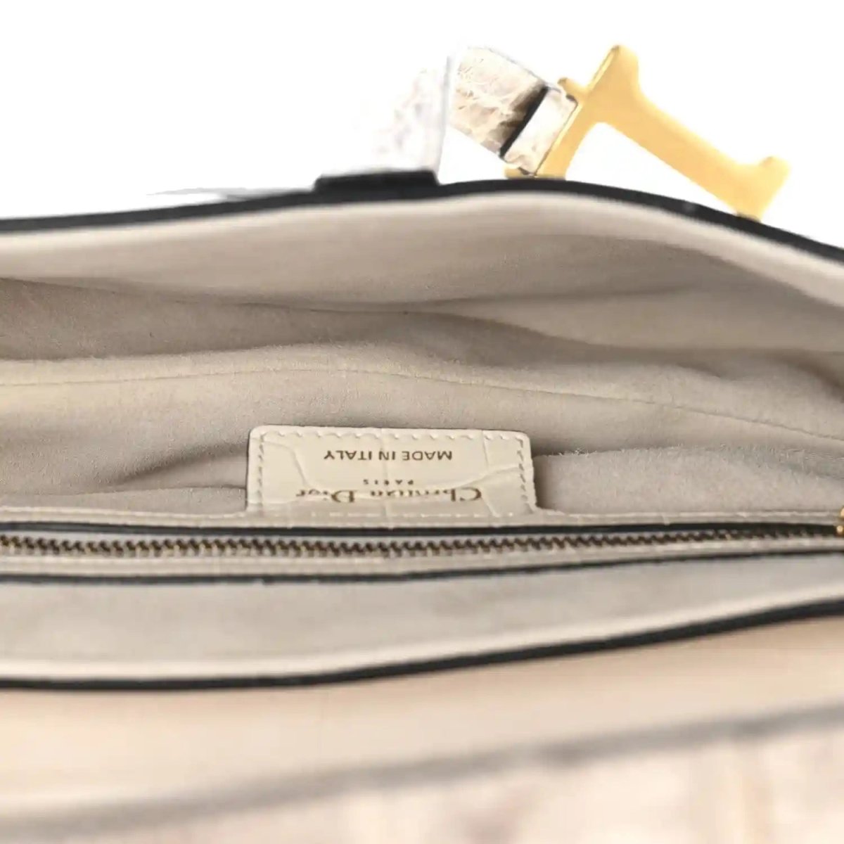 Leather saddle bag interior with fabric label under zipper trim