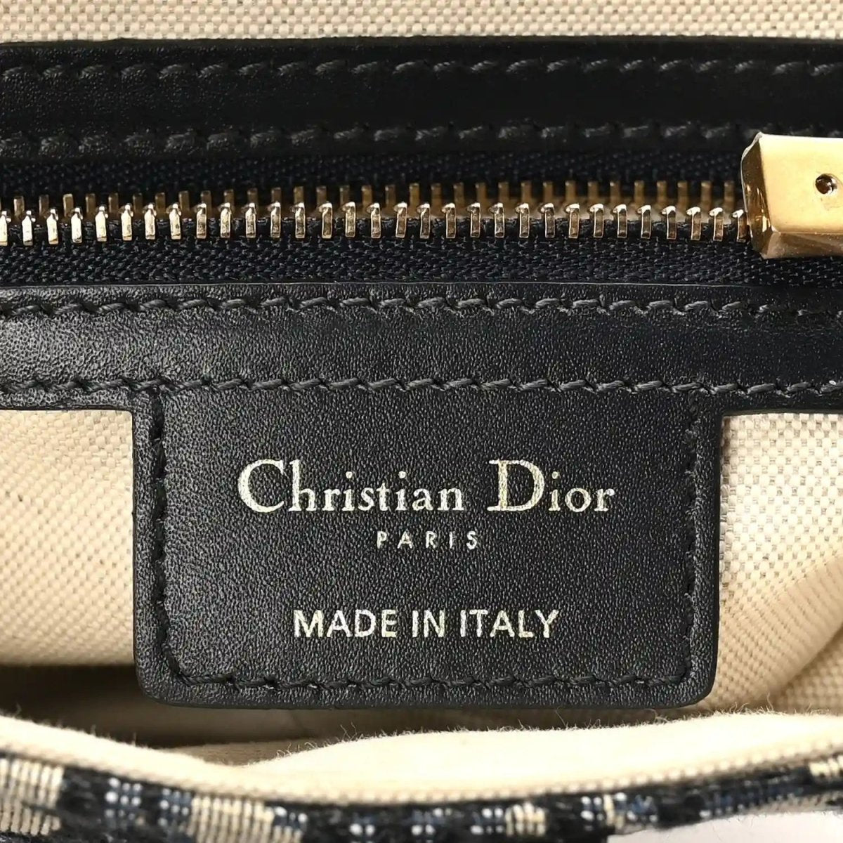 Christian Dior bag label on black leather tab: Christian Dior PARIS MADE IN ITALY