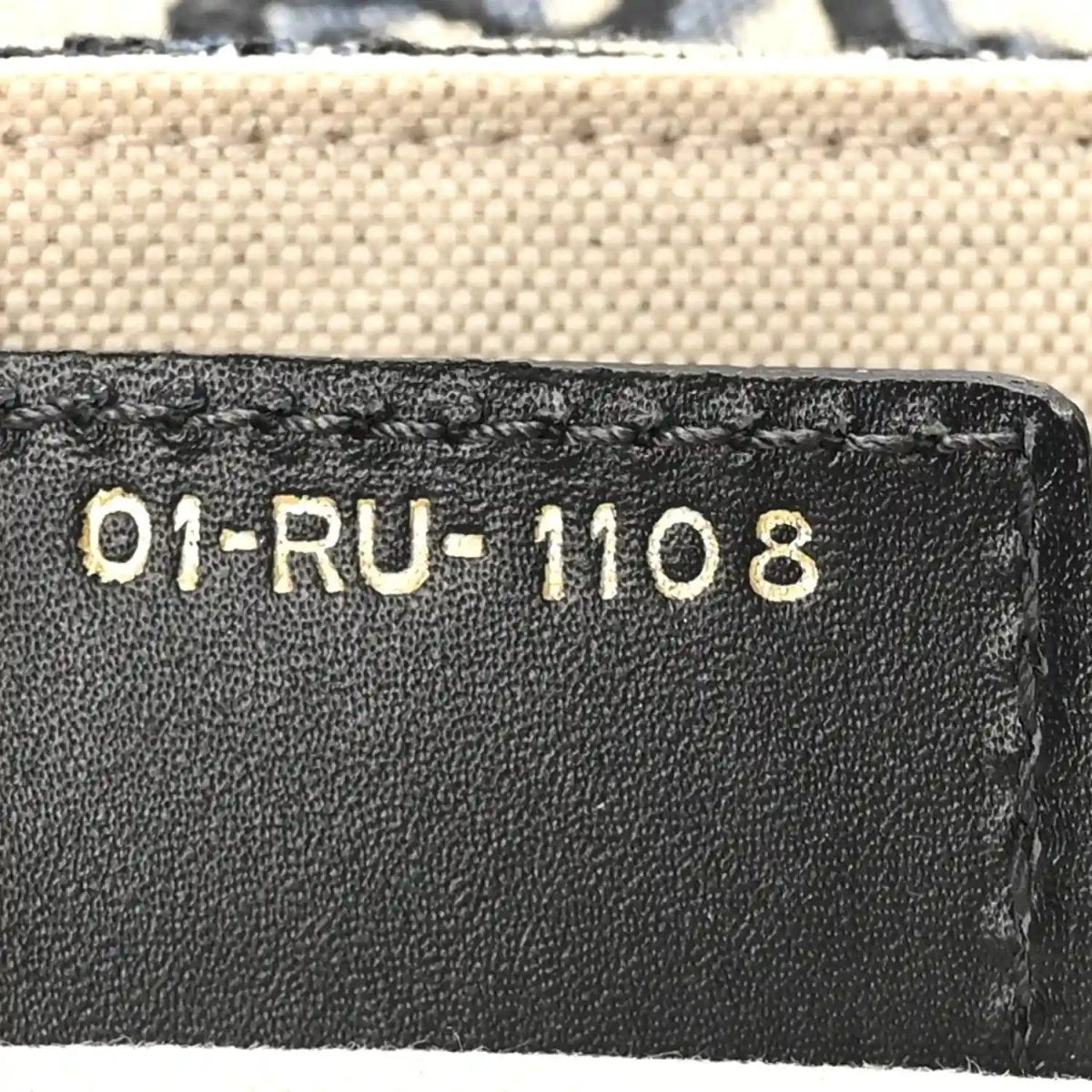Leather interior tag with code “01-RU-1108” on black lining