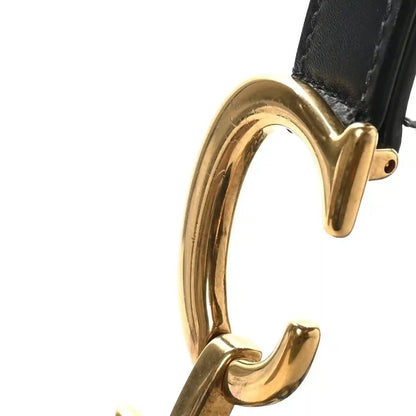 Saddle shoulder bag strap hardware with gold-tone D-ring and black leather strap